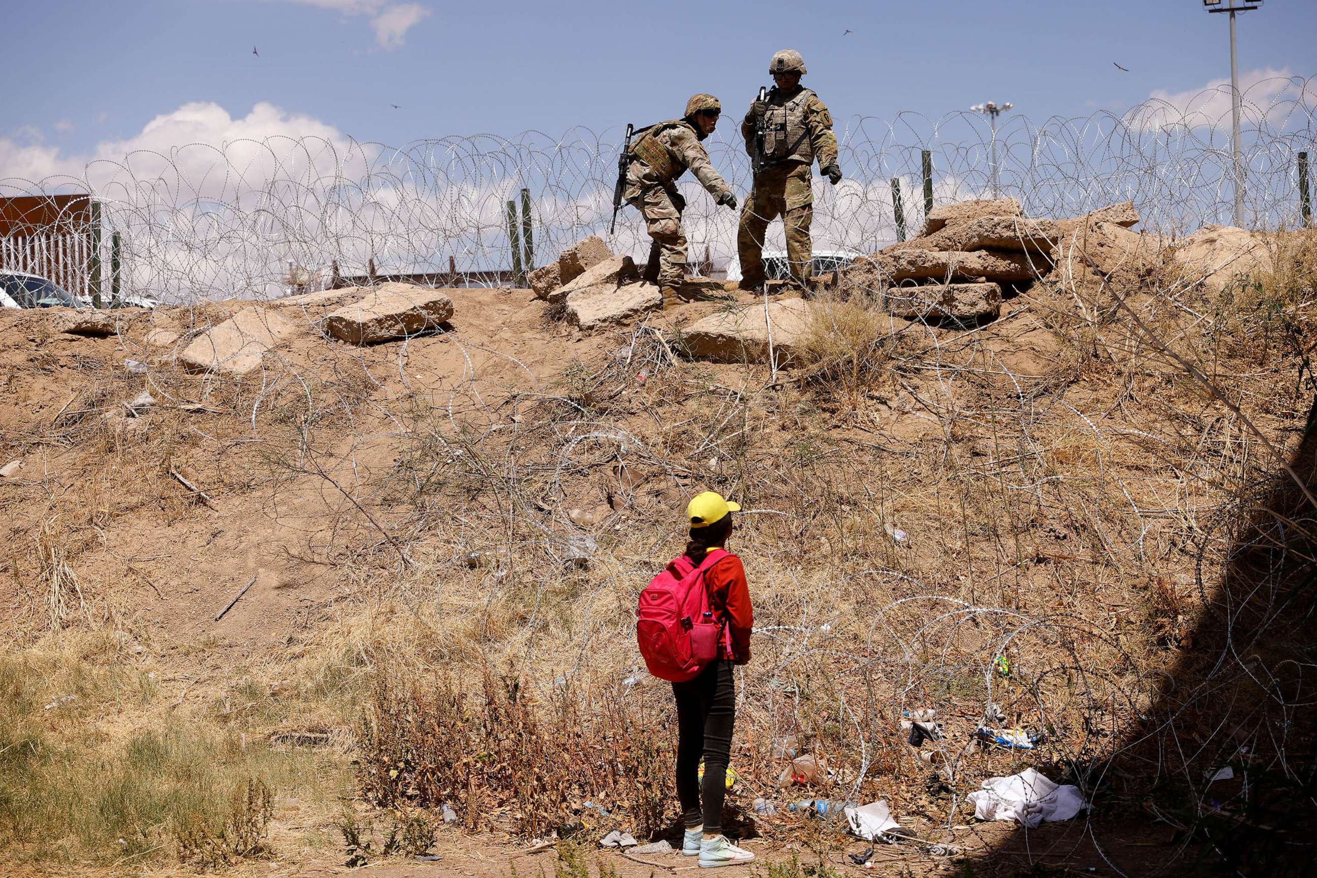 PHOTO: FILE - A young migrant, traveling alone from Guatemala, stands near the Rio Bravo river after crossing the border, to request asylum in the United States, as members of the Texas Army National Guard extend razor wire to inhibit migrants crossing
