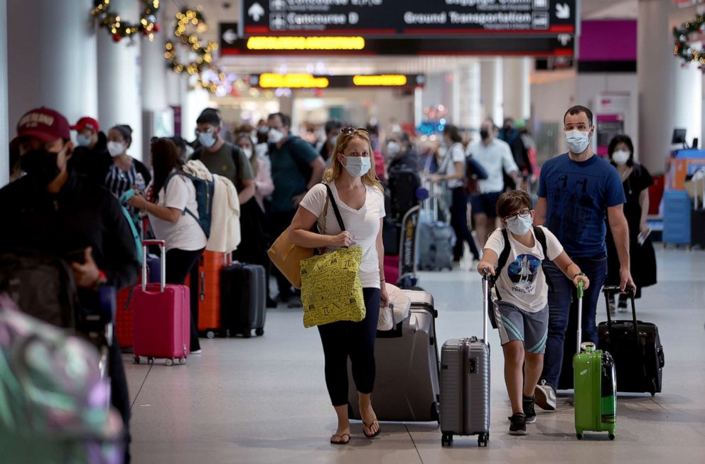 PHOTO: Travelers make their way through Miami International Airport on Dec. 28, 2021, in Miami.