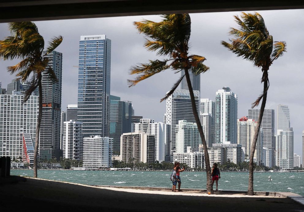 PHOTO: People take photos in front of the Miami skyline on March 28, 2019.