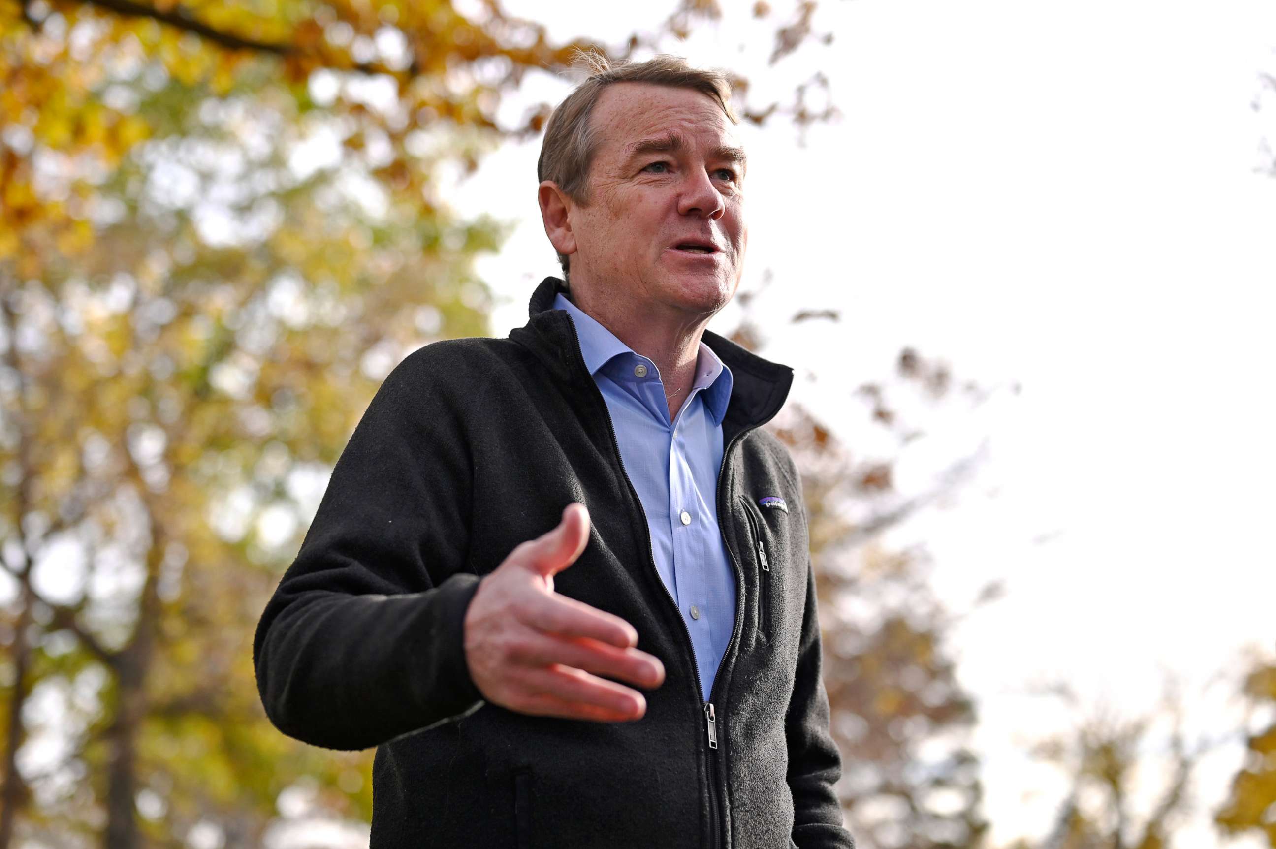 PHOTO: Sen. Michael Bennet answers questions from reporters after dropping off his ballot at Washington Park in Denver, Nov. 2, 2022.