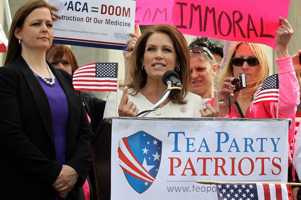 PHOTO: In this March 28, 2012, file photo, Rep. Michele Bachmann speaks as Tea Party Patriots national coordinator Jenny Beth Martin (L) listens on during a rally in front of the U.S. Supreme Court in Washington, D.C.