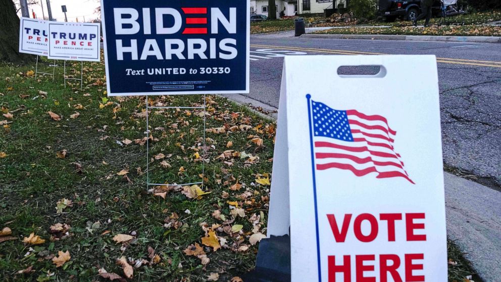 PHOTO: Trump signs and Biden signs are seen near Eisenhower Elementary School a polling area in Flint, Mich., Nov. 3, 2020.