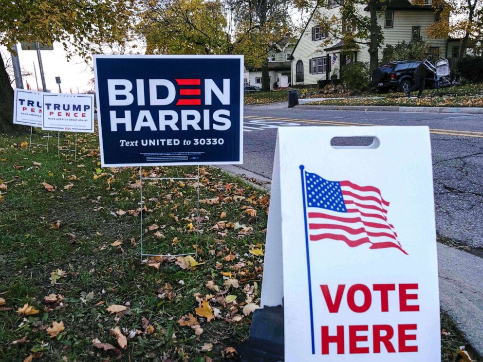 PHOTO: Trump signs and Biden signs are seen near Eisenhower Elementary School a polling area in Flint, Mich., Nov. 3, 2020.