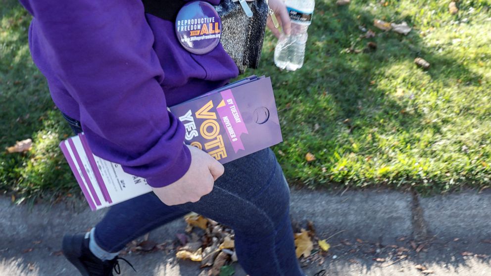 PHOTO: A digital media manager for Reproductive Freedom for All, canvasses a neighborhood in support of Proposal 3, a ballot measure that would codify the right to an abortion, one day before the midterm election in Dewitt, Mich., Nov. 7, 2022. 
