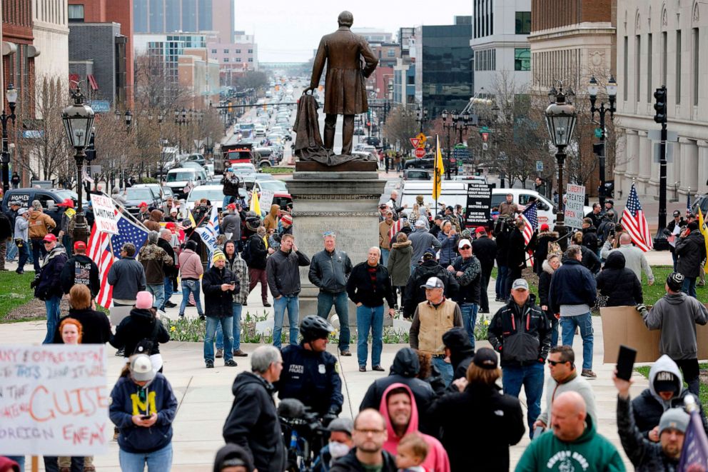 PHOTO: People protest against excessive quarantine amid the coronavirus pandemic at the Michigan State Capitol in Lansing, Michigan on April 15, 2020.