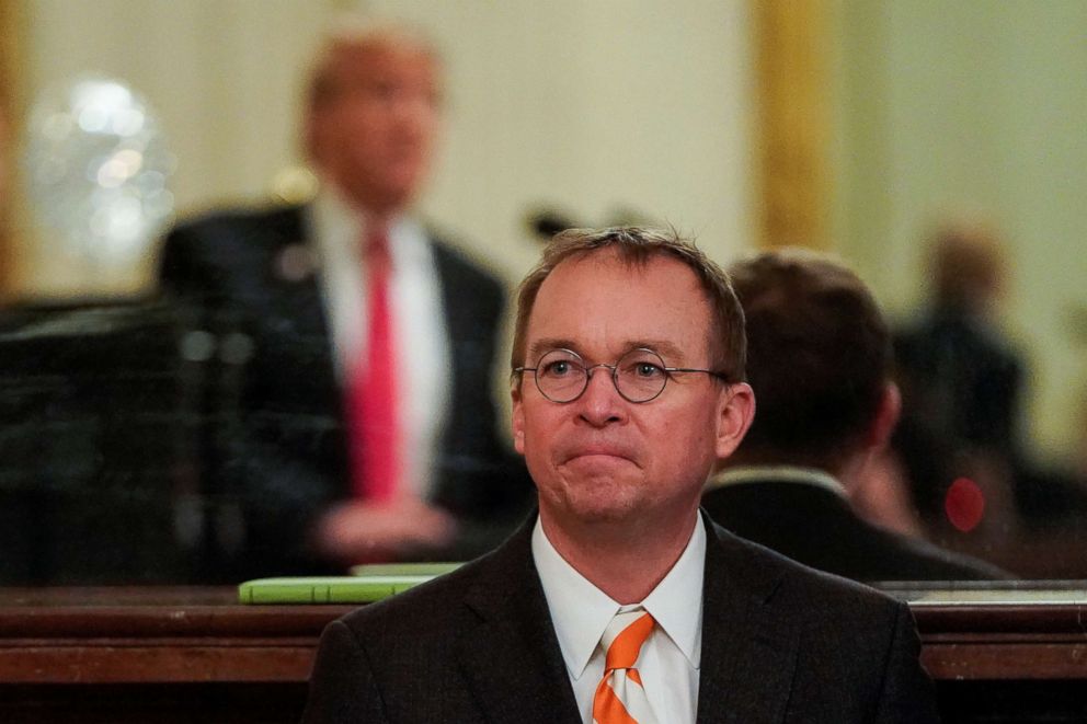 PHOTO: White House Acting Chief of Staff Mick Mulvaney  watches as President Donald Trump welcomes the 2018 College Football Playoff National Champion Clemson Tigers in the East Room of the White House in Washington, Jan. 14, 2019.