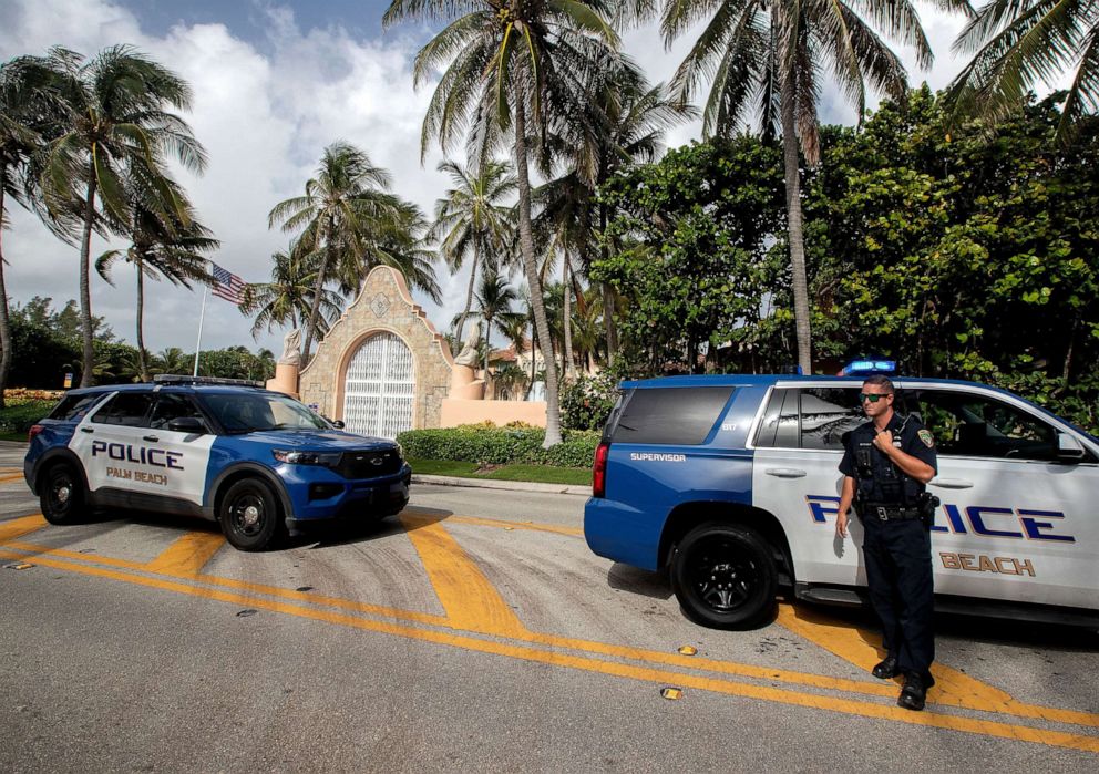 PHOTO: Authorities stand outside Mar-a-Lago, the residence of former president Donald Trump, amid reports of the FBI executing a search warrant as a part of a document investigation, in Palm Beach, Fla., Aug. 9, 2022.