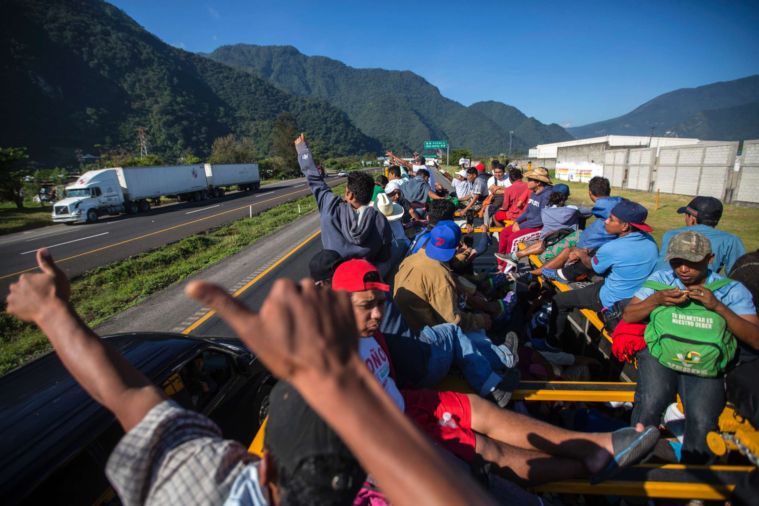 PHOTO: Central American migrants give a thumbs up to motorists who wave to them, as they begin their morning trek to reach the U.S. border as they leave Cordoba, Mexico, Nov. 5, 2018.