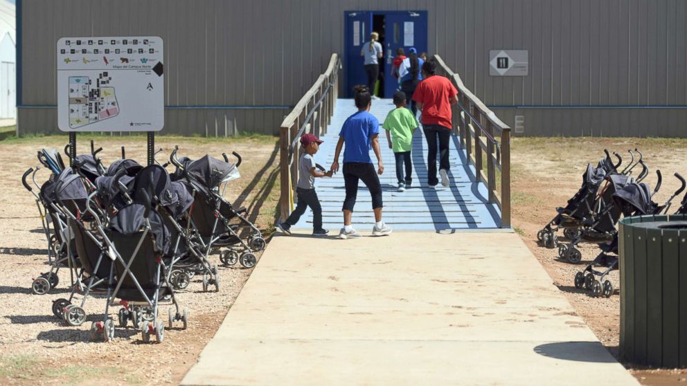 PHOTO: Immigrants walk into a building at South Texas Family Residential Center in Dilley, Texas, Aug. 9, 2018.