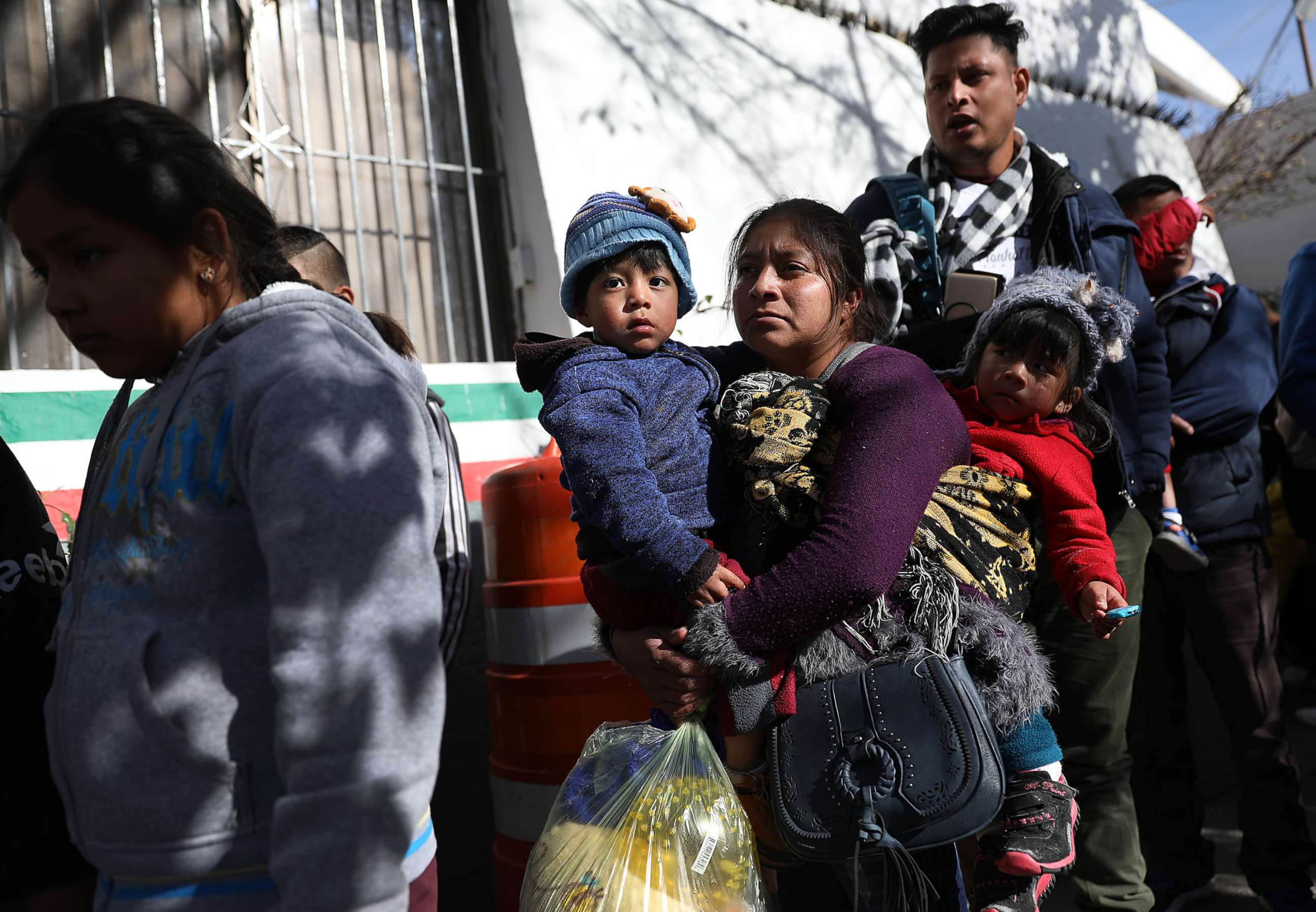 PHOTO: A group of people wait to cross the Paso Del Norte Port of Entry bridge to turn themselves in to the U.S. Customs and Border Protection personnel for asylum consideration on Jan. 13, 2019 in Ciudad Juarez, Mexico.