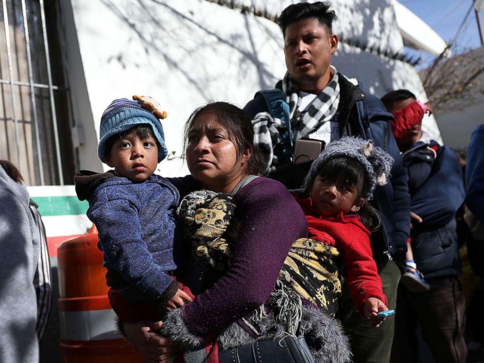 PHOTO: A group of people wait to cross the Paso Del Norte Port of Entry bridge to turn themselves in to the U.S. Customs and Border Protection personnel for asylum consideration on Jan. 13, 2019 in Ciudad Juarez, Mexico.