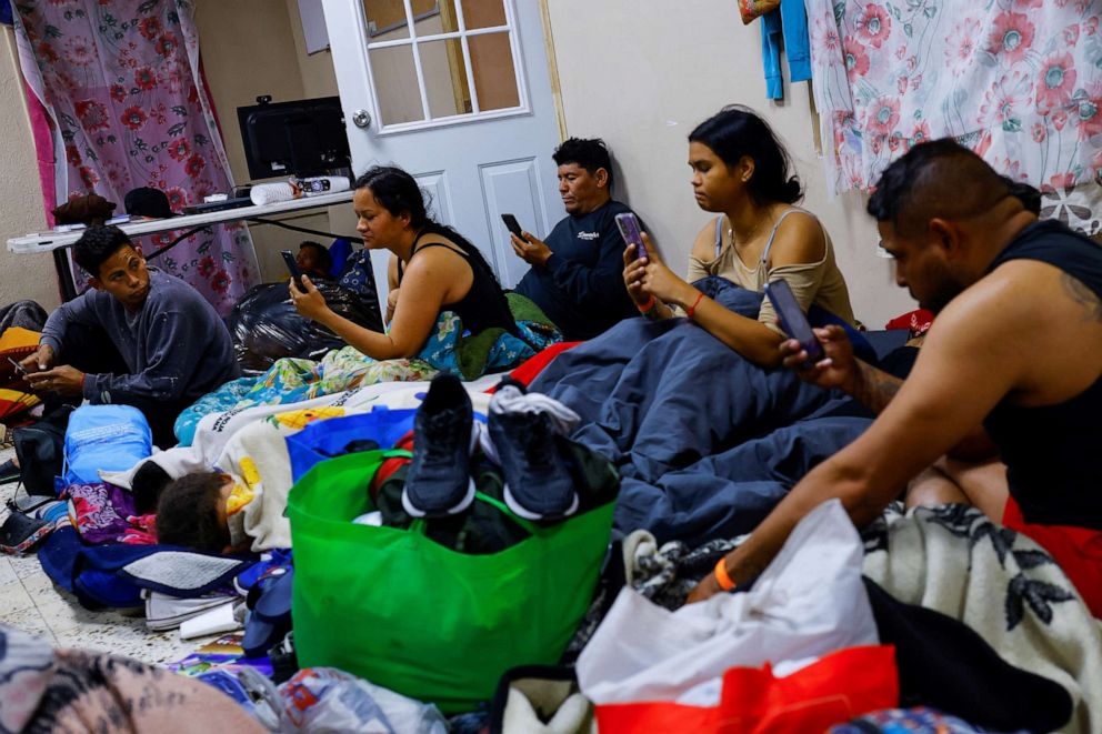 PHOTO: Migrants, mostly from Venezuela seeking asylum in the U.S., use their phones to access the U.S. Customs and Border Protection website in a shelter near the border between Mexico and the United States, in Ciudad Juarez, Mexico, Feb. 24, 2023.