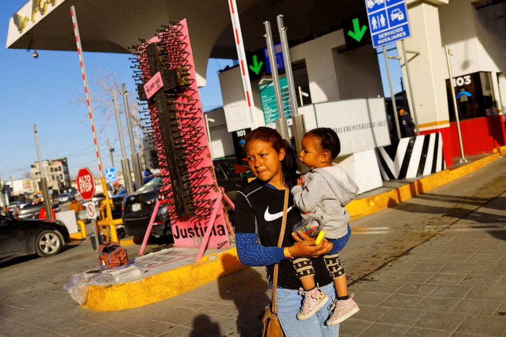 PHOTO: Angeldry Galeno, a Venezuelan migrant trying to apply for asylum in the United States holds her daughter as she walks near the border between Mexico and the United States, in Ciudad Juarez, Mexico, Feb. 24, 2023.