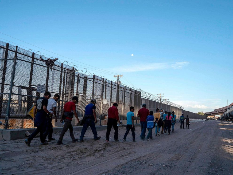 PHOTO: Migrants, mostly from Central America, que to board a van which will take them to a processing center, May 16, 2019, in El Paso, Texas.