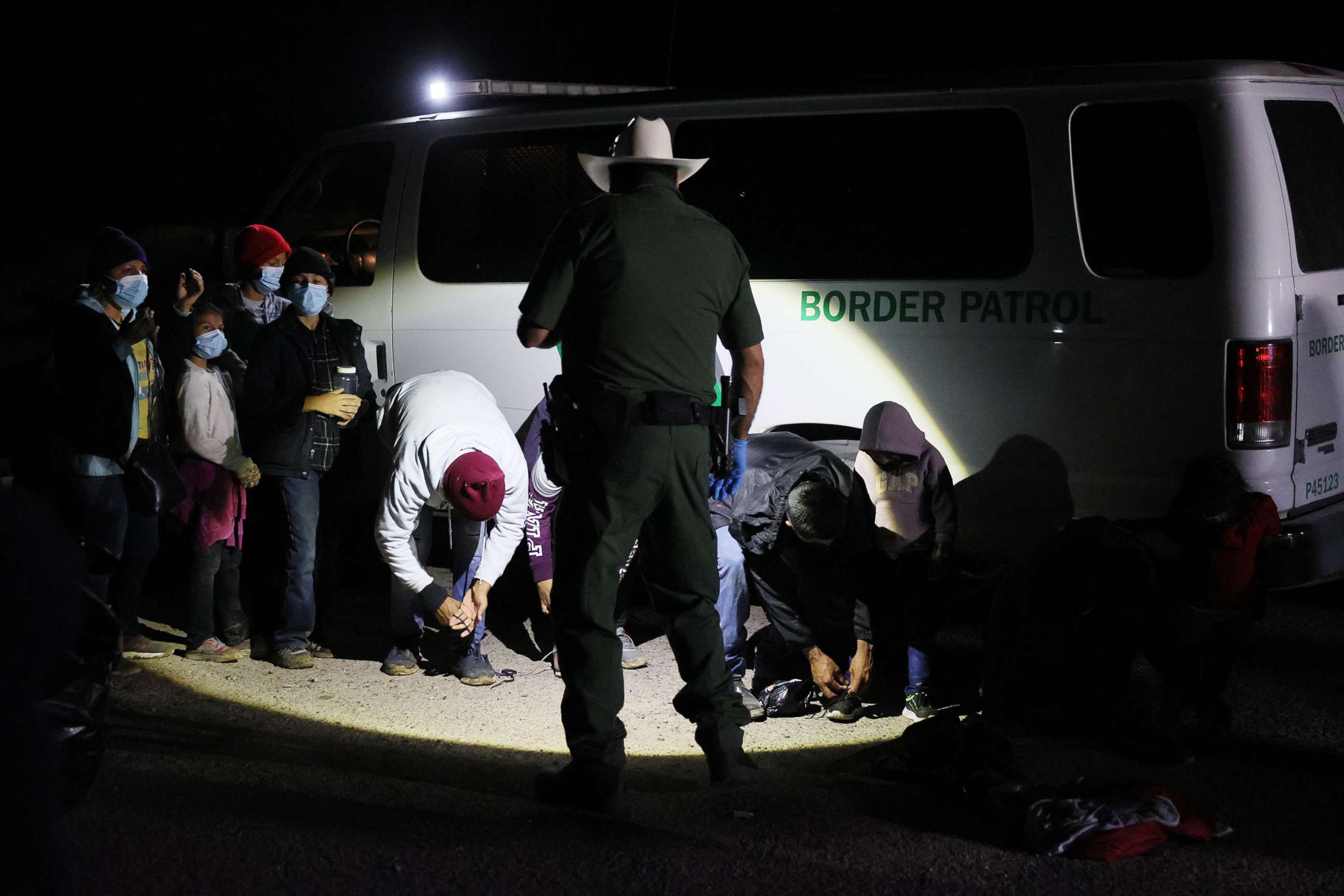 PHOTO: A group of migrants is processed by U.S. Border Patrol agents after arriving from Mexico on March 30, 2021 in Roma, Texas.