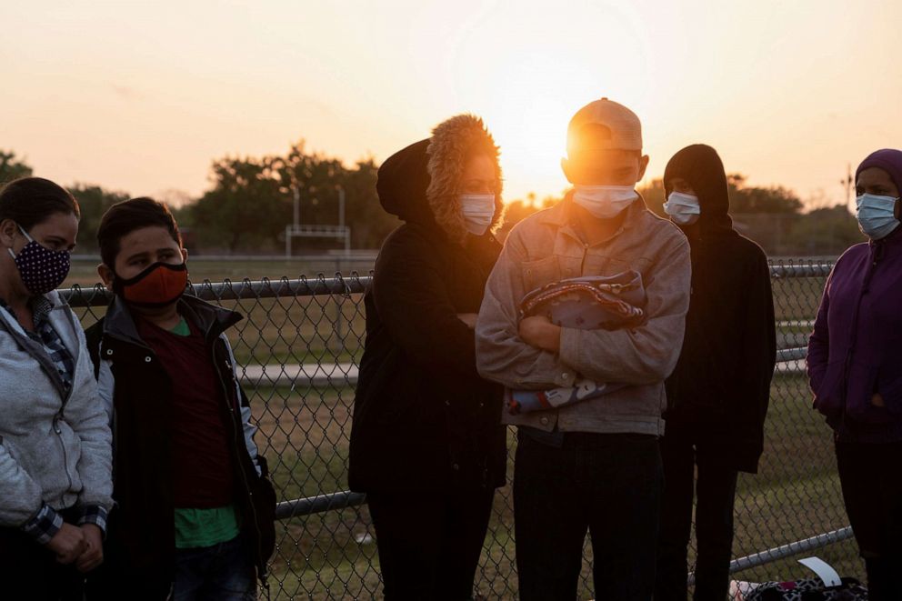 PHOTO: Asylum-seeking migrants' families wait to be transported by the U.S. Border Patrols after crossing the Rio Grande River into the United States from Mexico in La Joya, Texas, April 7, 2021.