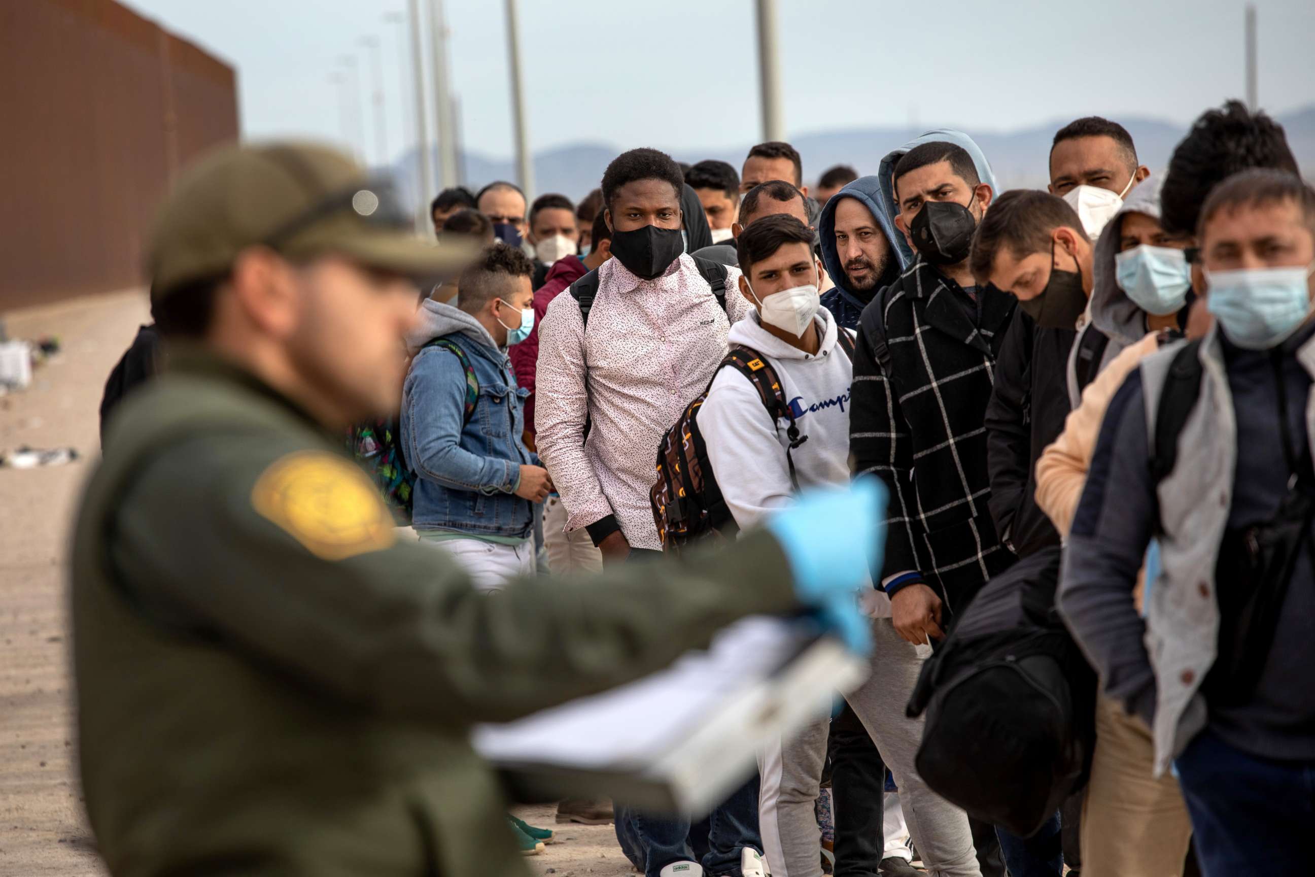 PHOTO: Immigrant men are taken into custody by U.S. Border Patrol agents at the U.S.-Mexico border, Dec. 7, 2021, in Yuma, Arizona.