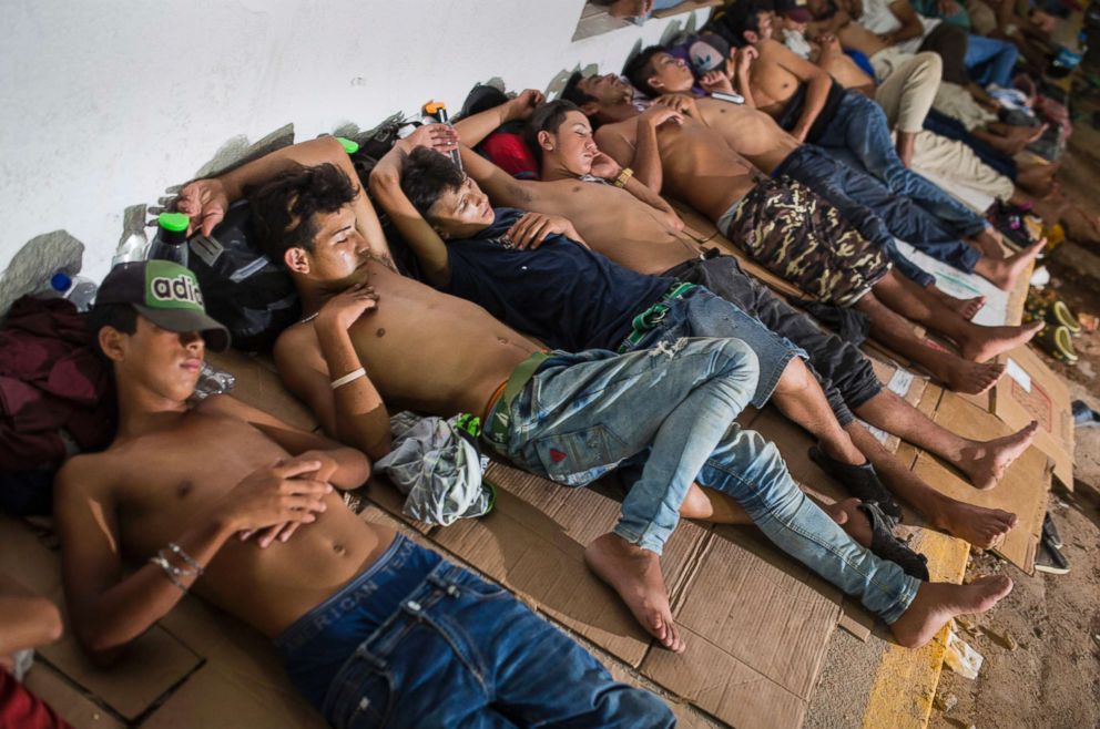 PHOTO: Young migrants rest on pieces of carton boards in Arriaga, Mexico, Oct. 26, 2018.