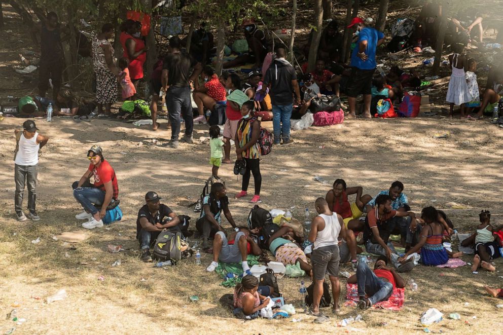 Asylum-seeking migrants rest under shade near the International Bridge between Mexico and the U.S. where asylum-seeking migrants are waiting to be processed in Del Rio, Texas on Sept. 15, 2021.