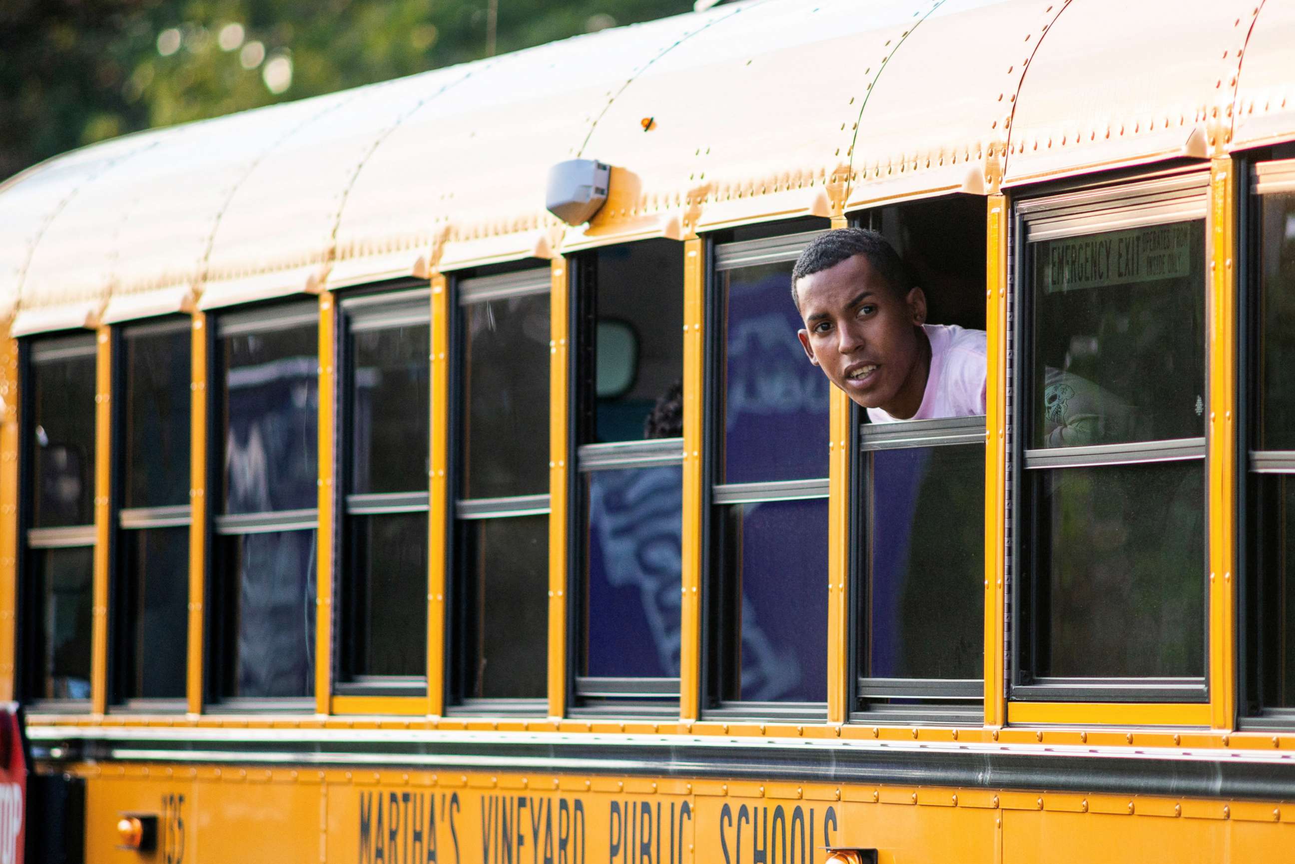 PHOTO: A migrant looks out of the window of a school bus being used to transport a group who arrived from Florida in Martha's Vineyard, Mass., Sept. 14, 2022.