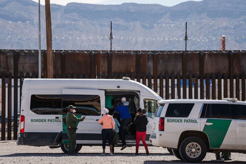 PHOTO: Border Patrol agents apprehend a group of migrants near downtown El Paso, Texas following the congressional border delegation visit on March 15, 2021.