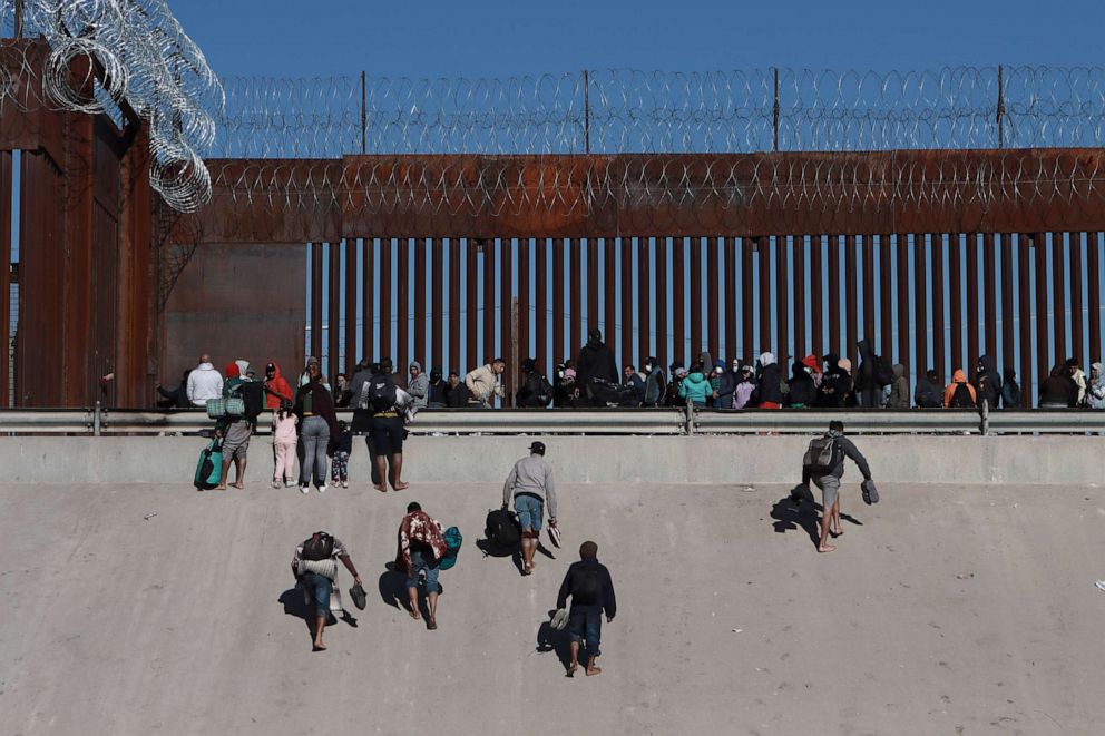 PHOTO: Migrants approach the border wall in Ciudad Juarez, Mexico, on Dec. 21, 2022, on the other side of the border from El Paso, Texas.