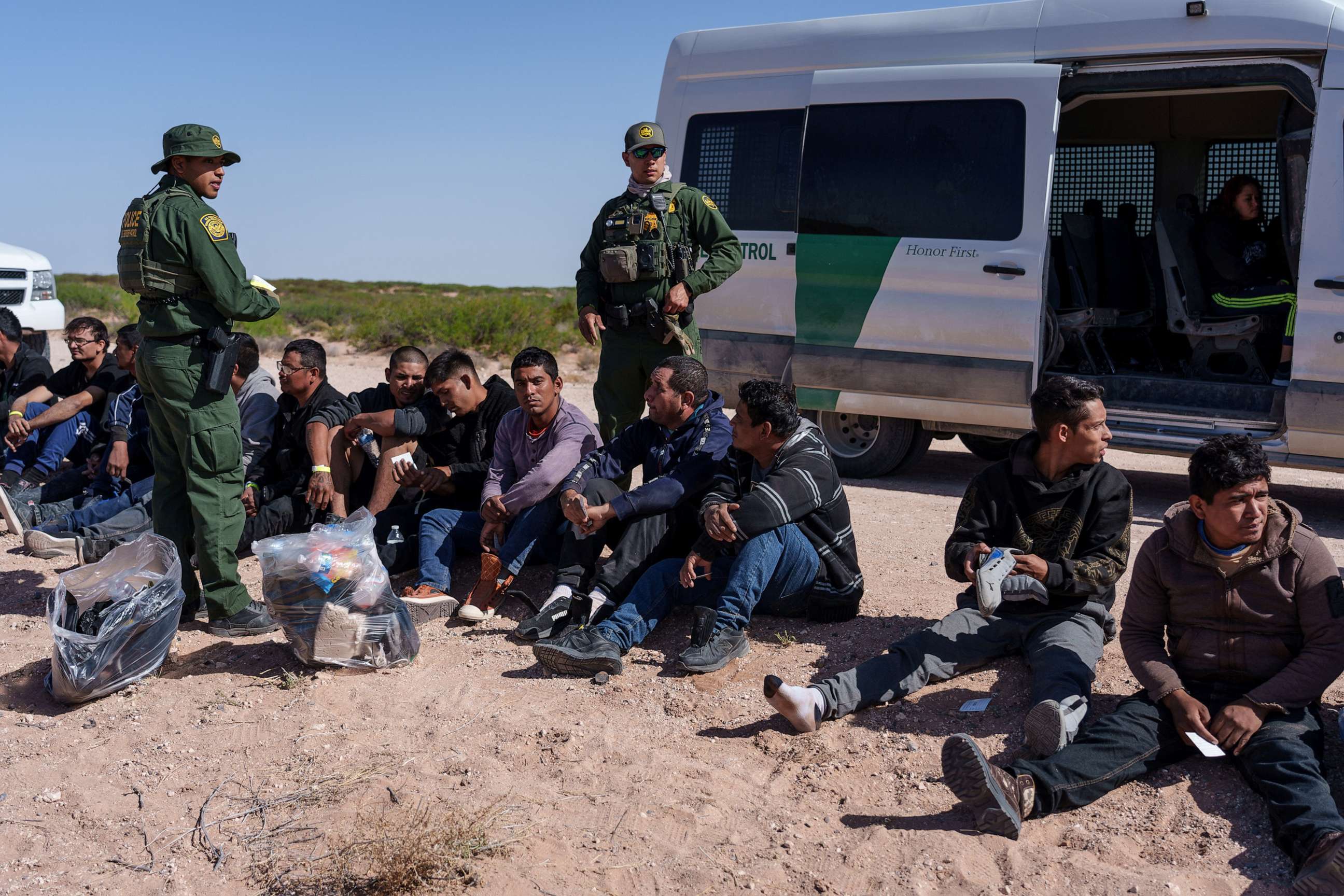 PHOTO: A group of 28 migrants wait to be processed by United States Border Patrol agents, after being apprehended trying to cross the border undetected, in Santa Teresa, New Mexico, April 26, 2023.
