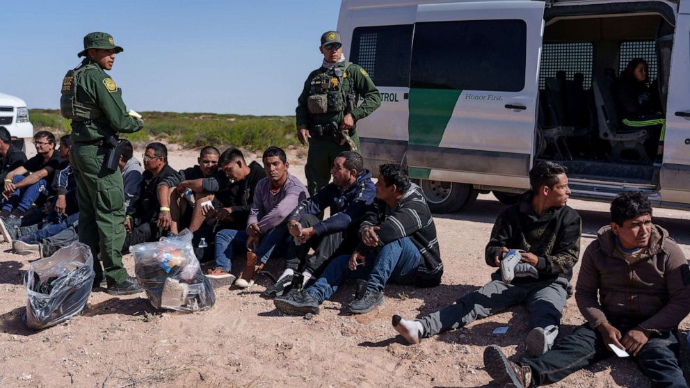 PHOTO: A group of 28 migrants wait to be processed by United States Border Patrol agents, after being apprehended trying to cross the border undetected, in Santa Teresa, New Mexico, April 26, 2023.