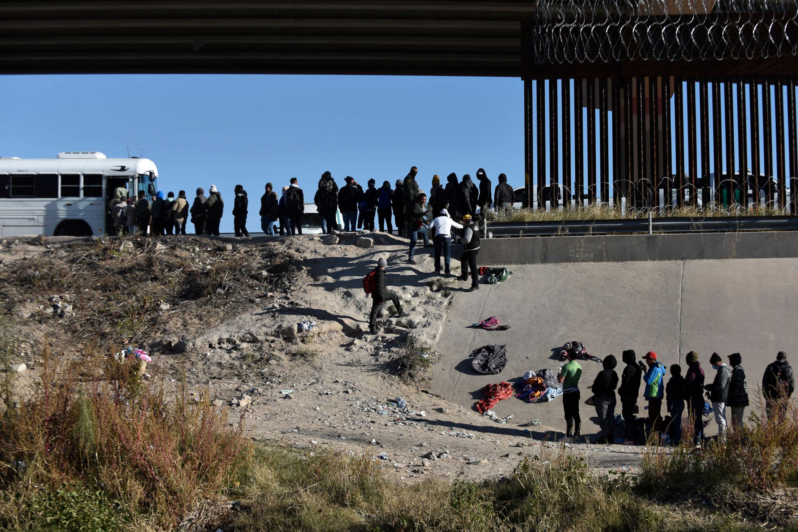 PHOTO: Migrants wait to get into a U.S. government bus after crossing the border from Ciudad Juarez, Mexico, to El Paso, Dec. 12, 2022.