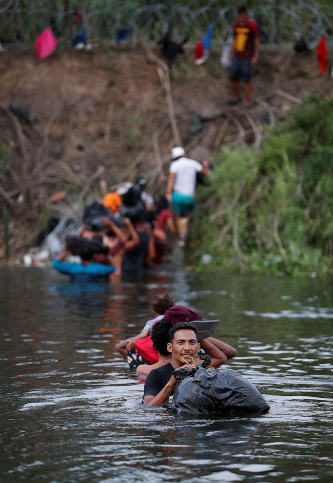 PHOTO: Migrants cross the Rio Bravo river to turn themselves in to U.S. Border Patrol agents before Title 42 ends, in Matamoros, Mexico May 10, 2023.