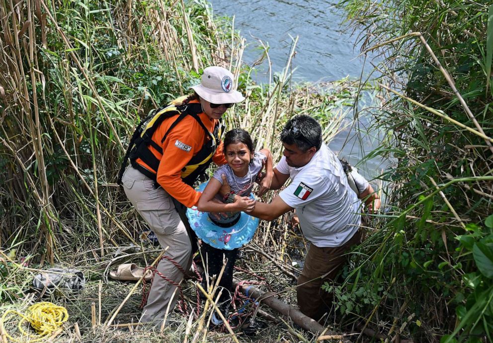PHOTO: A migrant girls who swam back to Mexico with her mother after reaching the US bank of the Rio Bravo river and being stopped by members of the US National Guard in Matamoros, state of Tamaulipas, Mexico, on May 10, 2023.