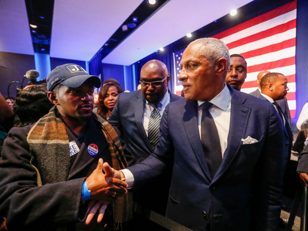 Democrat Mike Espy, right, who sought to unseat U.S. Sen. Cindy Hyde-Smith, R-Miss., shakes hands with a supporter in a crowded auditorium at the Mississippi Civil Rights Museum in Jackson, Miss., after losing the runoff election Tuesday, Nov. 27, 2018.