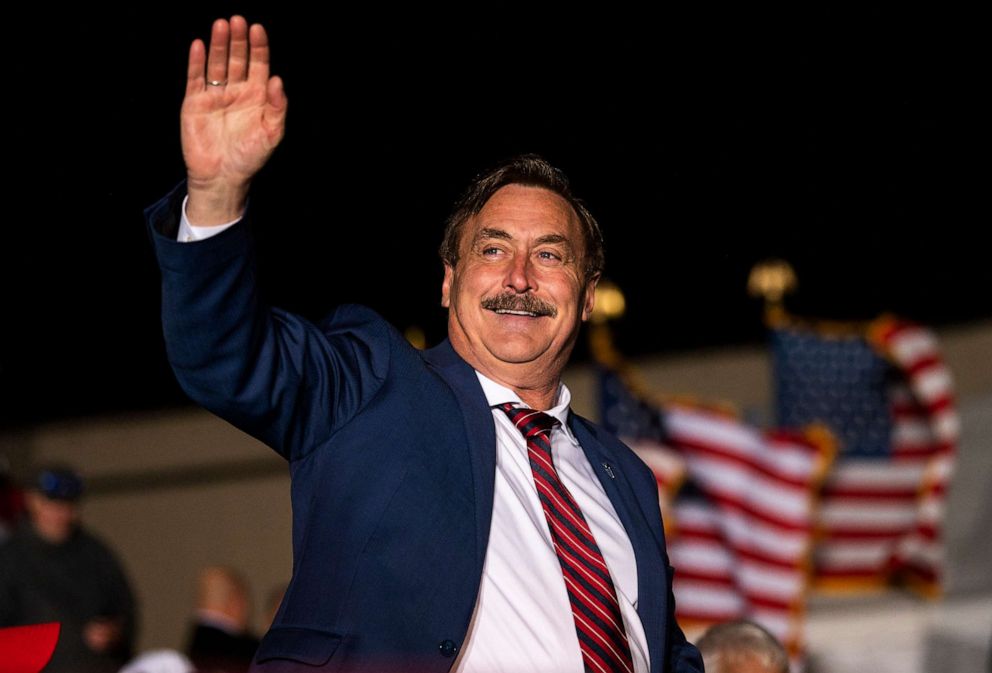 PHOTO: MyPillow CEO Mike Lindell waves as he is introduced while former U.S. President Donald Trump speaks during a campaign event at Sioux Gateway Airport, Nov. 3, 2022, in Sioux City, Iowa.