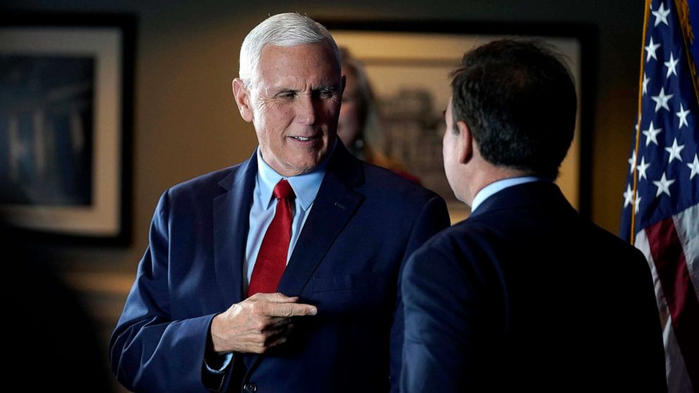 PHOTO: Former Vice President Mike Pence greets people while signing copies of his book "So Help Me God" before the start of a GOP fundraising dinner, March 16, 2023, in Keene, N.H.