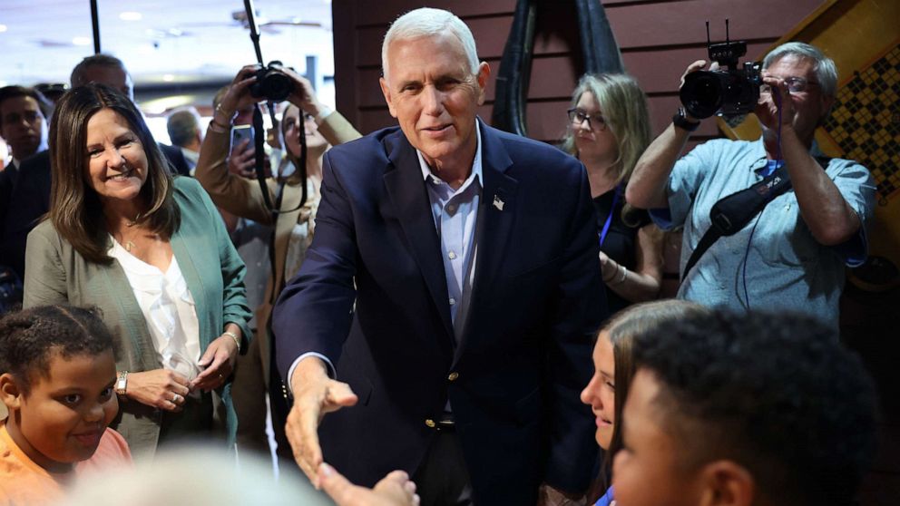 PHOTO: With his wife Karen by his side, former Vice President Mike Pence greets diners during a visit to a Pizza Ranch restaurant on June 08, 2023 in Waukee, Iowa.