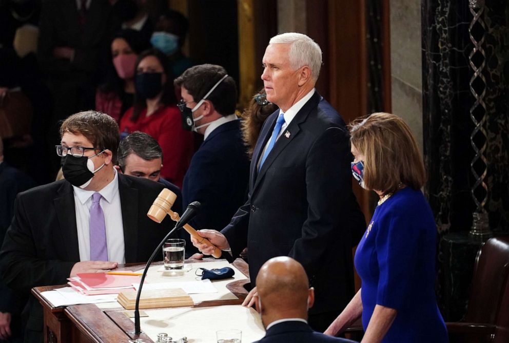 PHOTO: FILE - Vice President Mike Pence and U.S. House Speaker Nancy Pelosi are seen while presiding over a joint session of Congress to count the Electoral College votes of the 2020 presidential election in the House Chamber in Washington, D.C.,