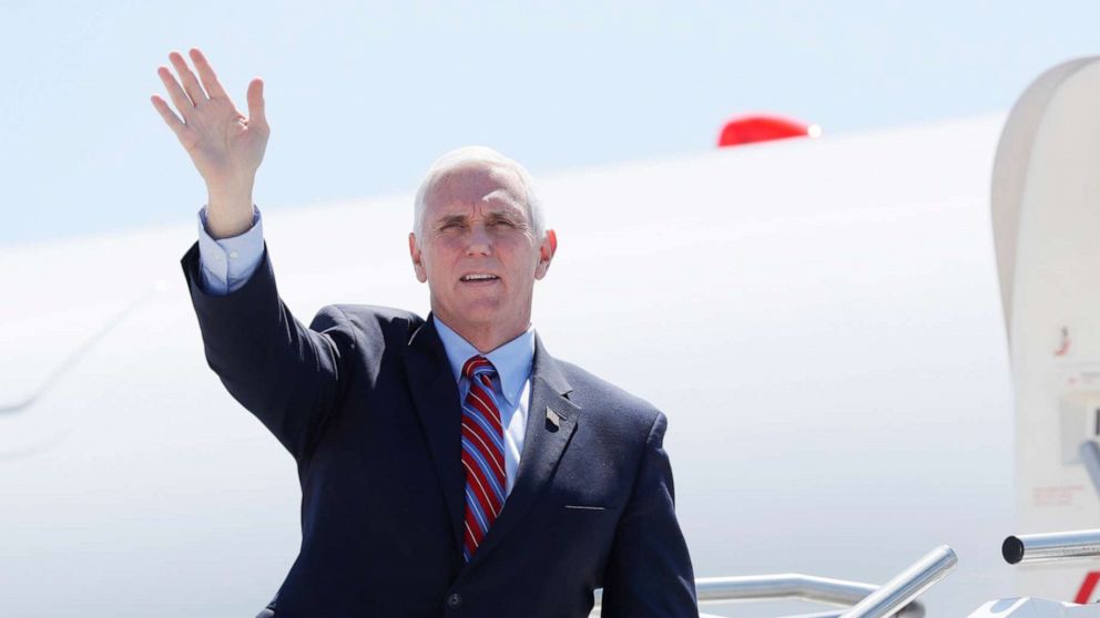 PHOTO: Vice President Mike Pence waves as he stops off Air Force Two after arriving at the Des Moines International Airport, May 8, 2020, in Des Moines, Iowa.