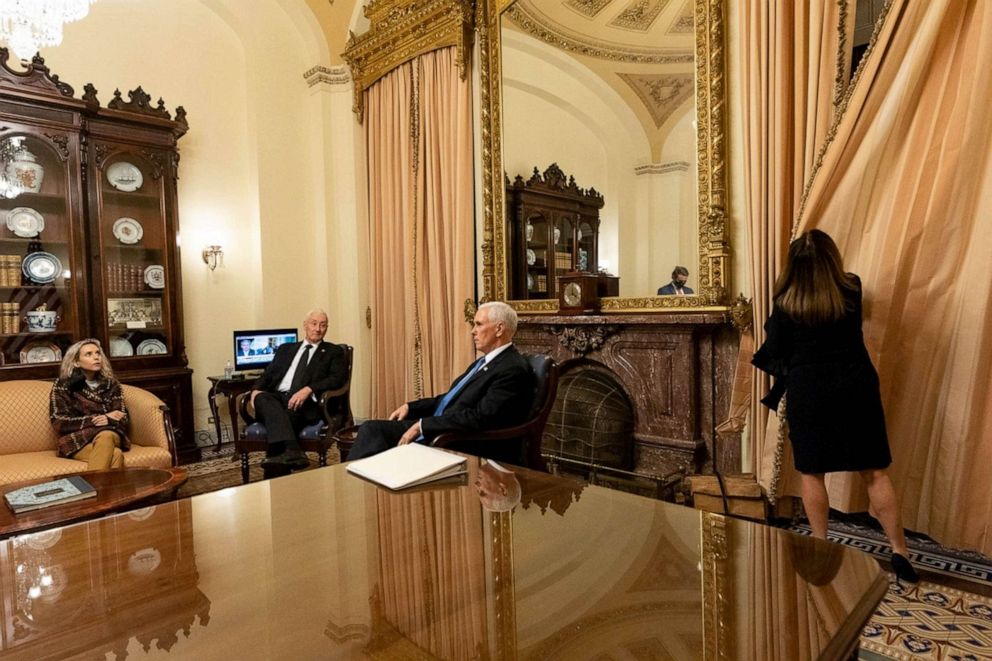 PHOTO: Vice President Mike Pence sits with daughter, Charlotte, and brother, Greg, as wife, Karen, draws the curtains, in ceremonial room off Senate floor where he was evacuated as Trump supporters attacked U.S. Capitol, Jan. 6, 2021.
