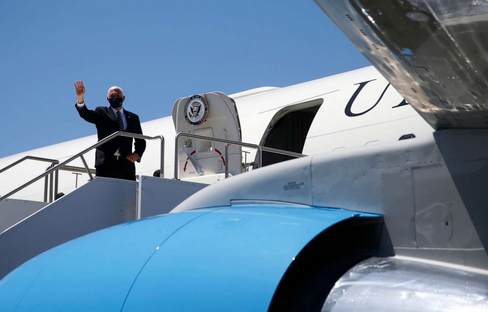 PHOTO: Vice President Mike Pence waves as he boards Air Force Two after meeting with Arizona Gov. Doug Ducey to discuss the surge in coronavirus cases in Arizona Wednesday, July 1, 2020, in Phoenix.