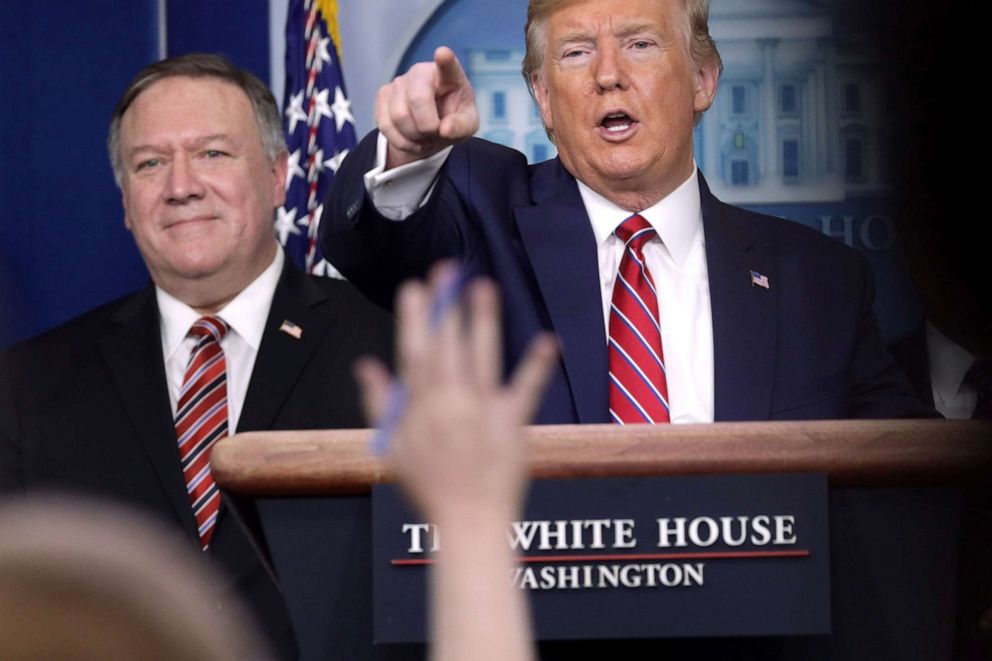 PHOTO: President Donald Trump takes questions as Secretary of State Mike Pompeo looks on during a news briefing at the White House,  March 20, 2020.