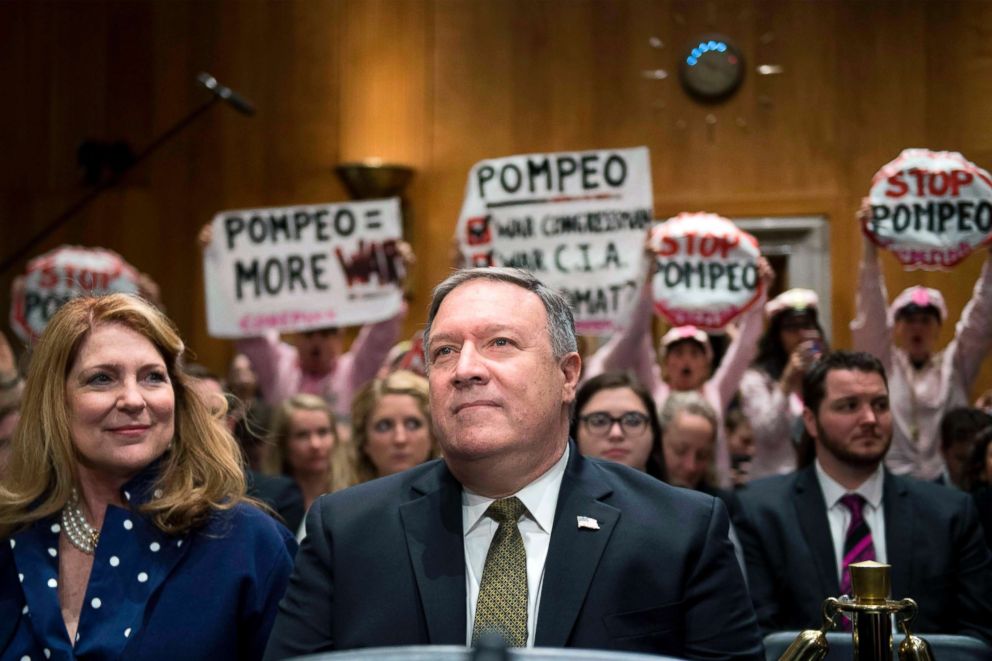 PHOTO: Protesters stand and chant with placards as U.S. Secretary of State nominee Mike Pompeo arrives to testify before the Senate Foreign Relations Committee during his conformation hearing on Capitol Hill in Washington, DC, April 12, 2018.
