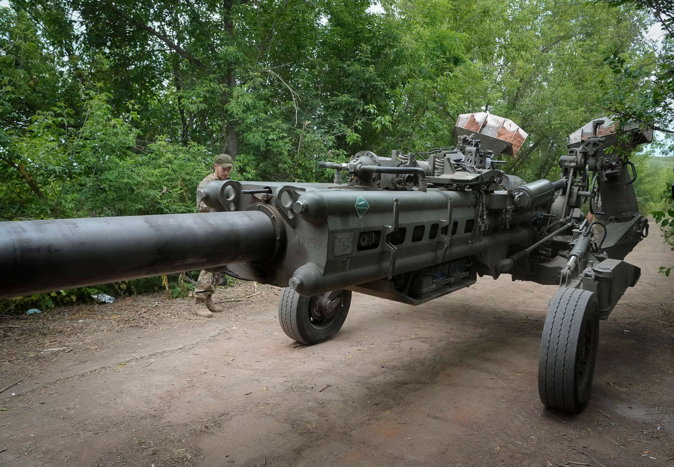 PHOTO: Ukrainian soldiers move a U.S.-supplied M777 howitzer into position to fire at Russian positions in Ukraine's eastern Donetsk region, June 18, 2022.