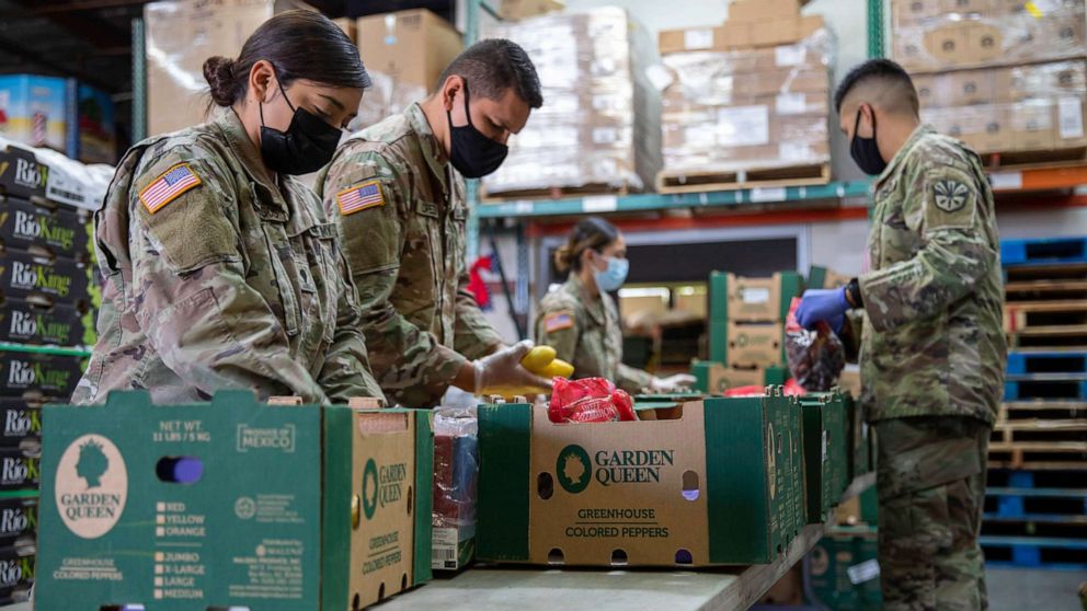 PHOTO: Soldiers with the Arizona National Guard load boxes with fresh produce at a local food bank in Phoenix, Ariz., May 21, 2021.