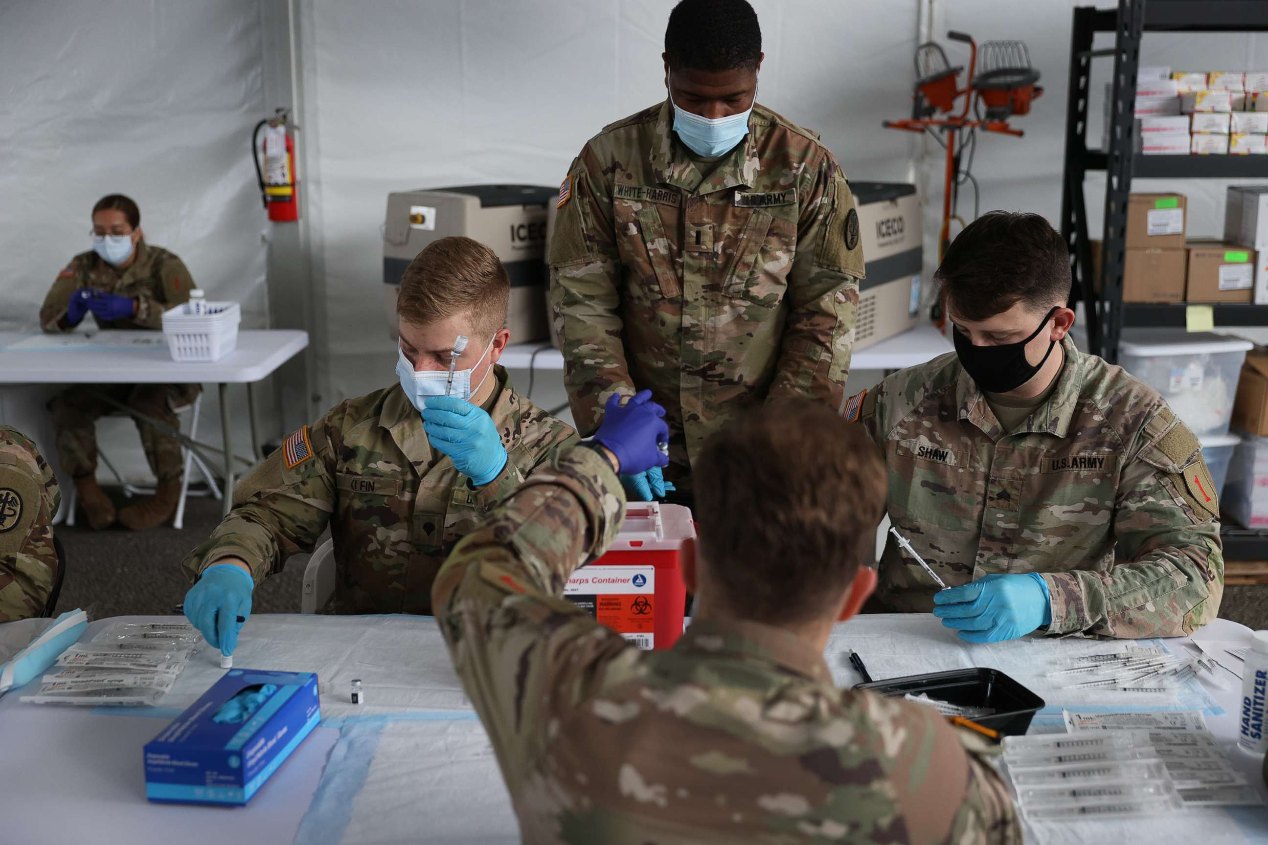 PHOTO: U.S. Army soldiers from the 2nd Armored Brigade Combat Team, 1st Infantry Division, prepare Pfizer COVID-19 vaccines to inoculate people at the Miami Dade College North Campus on March 9, 2021 in Miami.