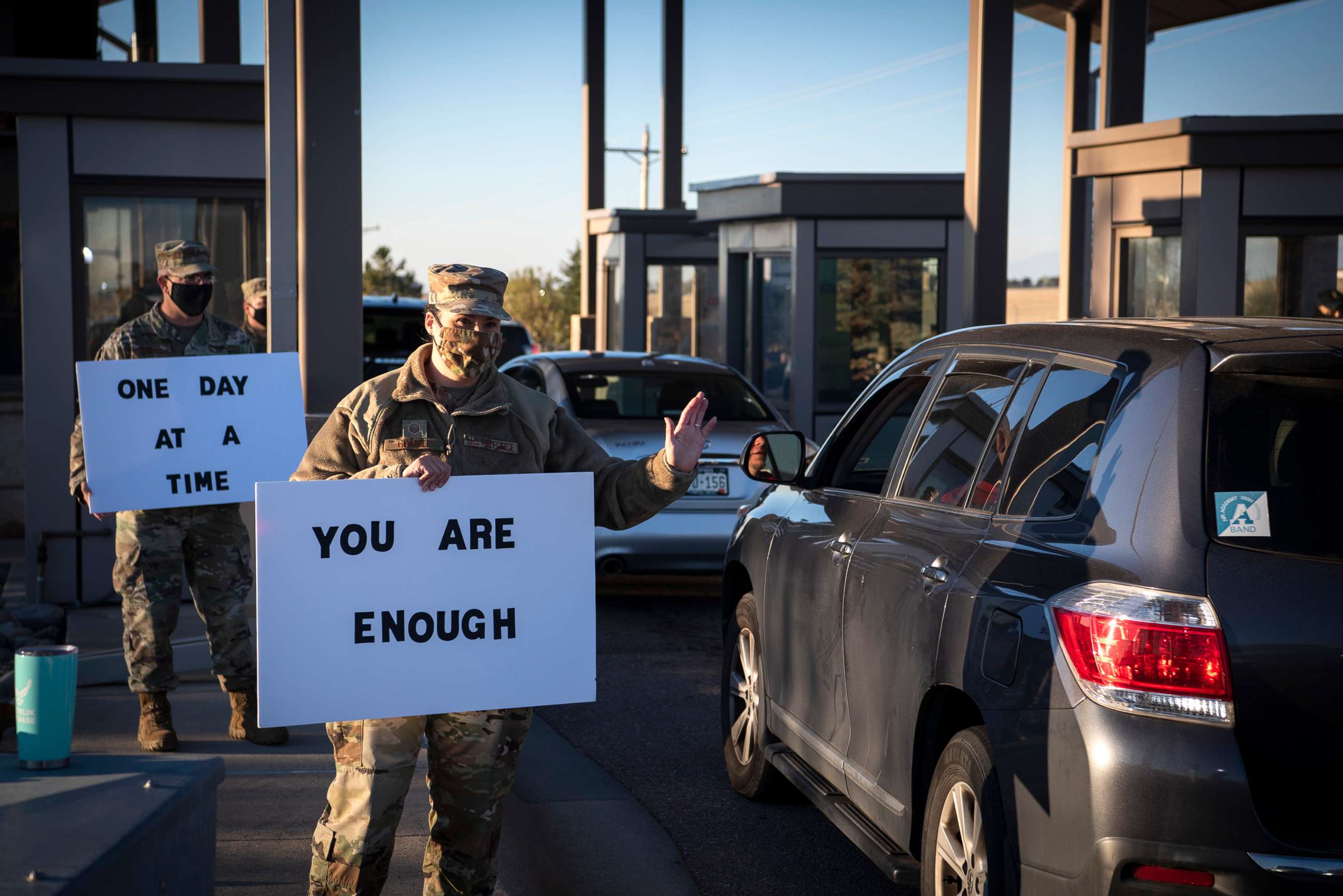 PHOTO: Master Sgt. Erin Kirby-Guanill, greets members at the Schriever North gate, Sept. 29, 2020, at Schriever Air Force Base, Colorado to spread a positive message to members who entered the installation.
