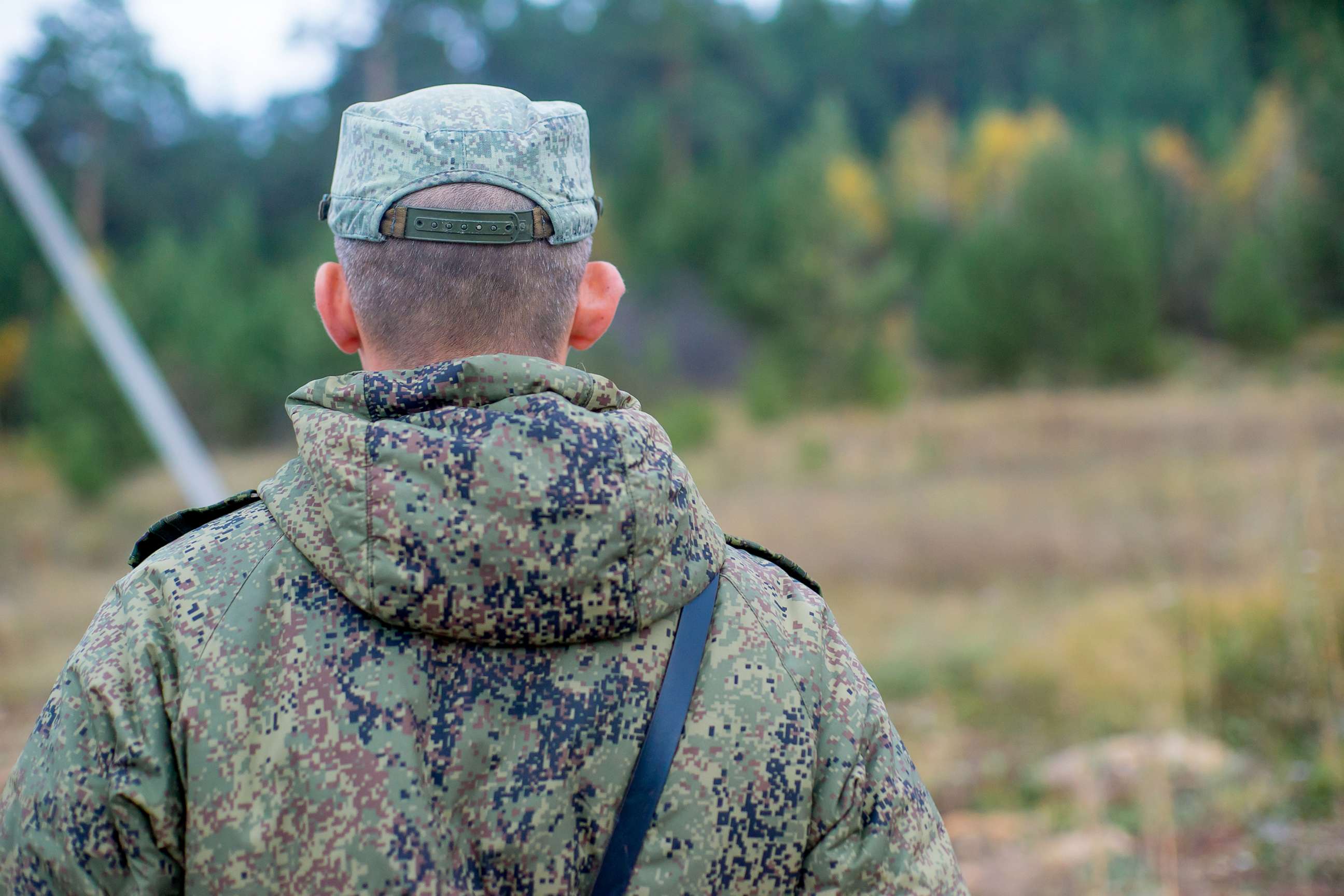 PHOTO: a portrait of a brave soldier standing outside