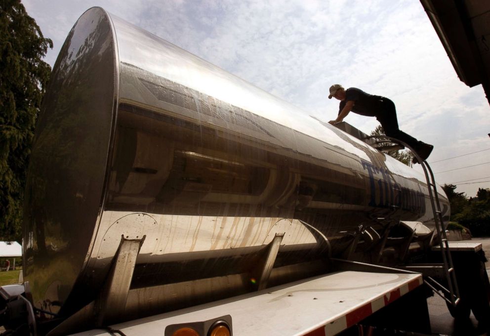 PHOTO: A dairy delivery truck driver checks his tank after unloading milk in Beaverton, Ore., July 2, 2008.  