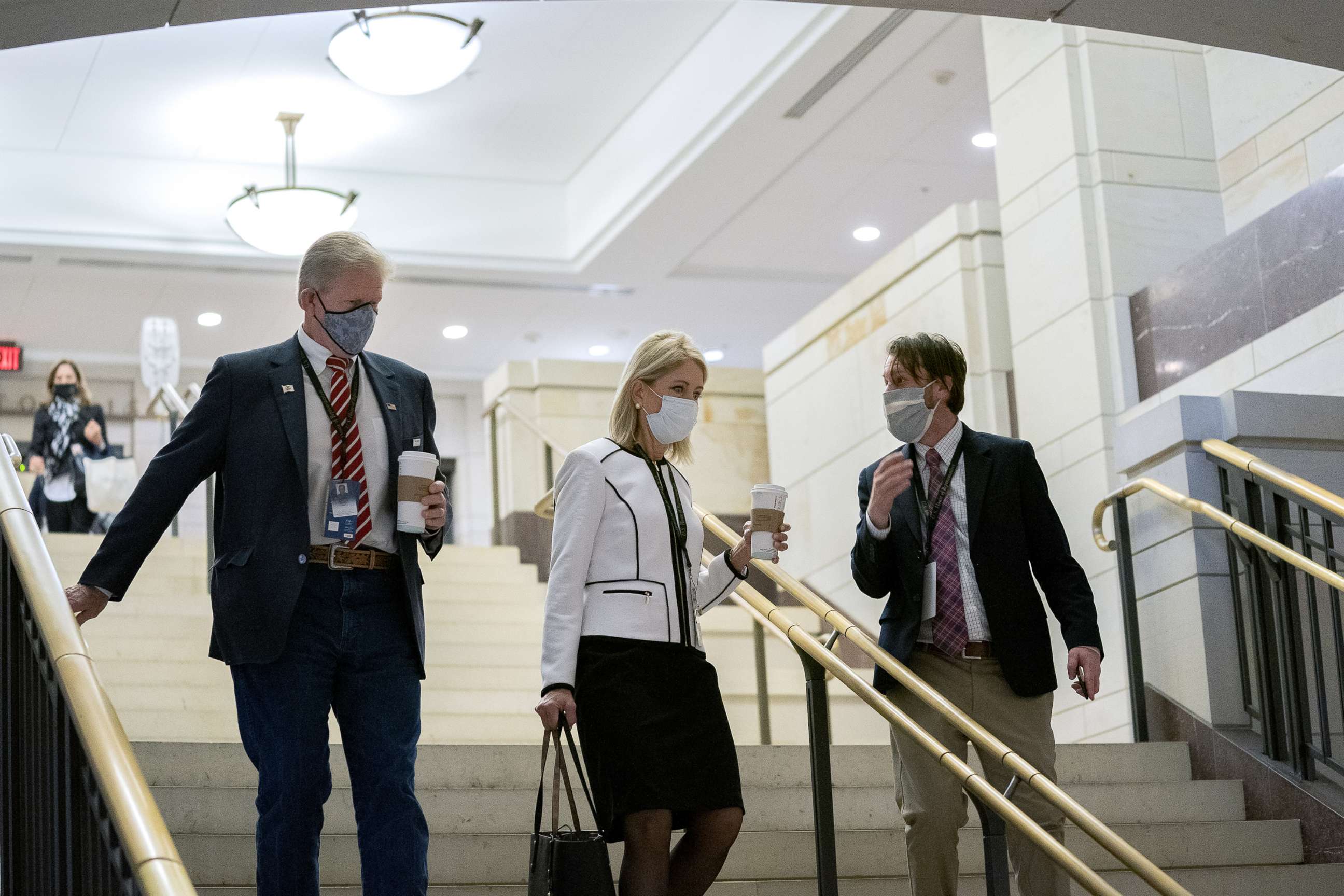 PHOTO: Representative-elect Chris Miller, a Republican from Illinois, left, and Representative-elect Mary Miller, a Republican from Illinois, center, wear protective masks while arriving to a new member briefing at the Capitol, Nov. 13, 2020.