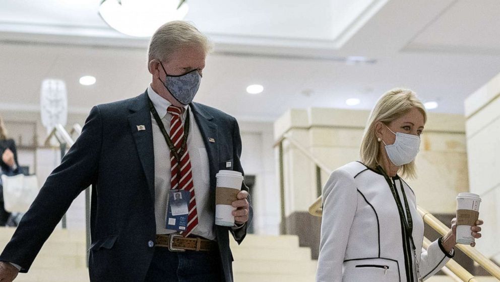 PHOTO: Representative-elect Chris Miller, a Republican from Illinois, left, and Representative-elect Mary Miller, a Republican from Illinois, center, wear protective masks while arriving to a new member briefing at the Capitol, Nov. 13, 2020.