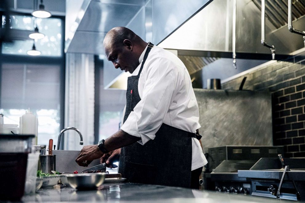 PHOTO: Chef Erick Williams prepares a dish at Virtue Restaurant and Bar in Chicago, Il., June 19, 2019.